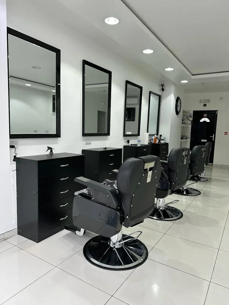 The clean, modern interior of Clippers Barbers in Grays, with black barber chairs and mirrors