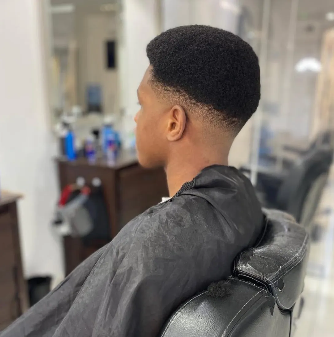 Fresh afro cut with a clean taper